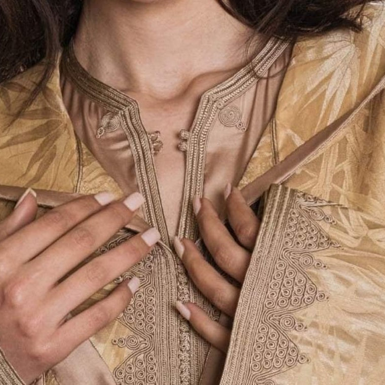 Gold jacquard hooded Moroccan djellaba, hand-embroidered placket seen close