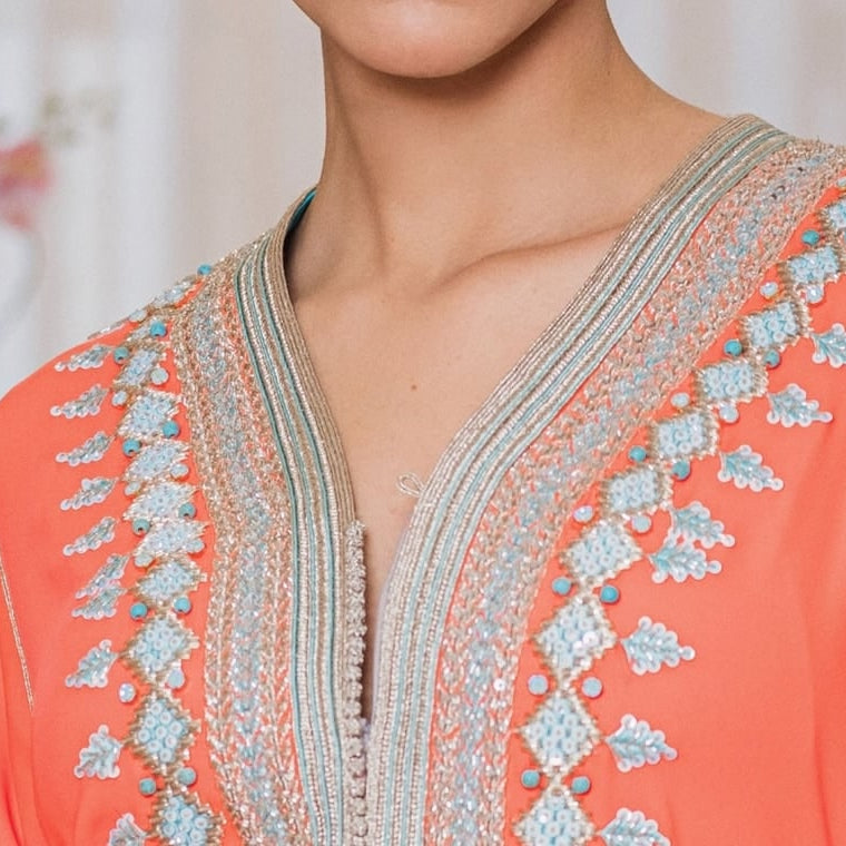 Persimmon one-piece Moroccan caftan with a silver hand-worked braid from collar to hem