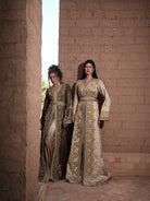 Alabaster Aria quilted ivory brocade Moroccan kaftan with gold sequin embroidery and belted waist, shown alongside a second look