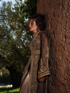 Bronze Reverie lamé organza Moroccan kaftan with gold embroidery, worn open over a champagne dress